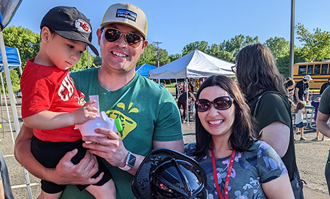 Family smiling at Touch A Truck event